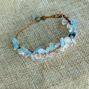 Close-up of natural aquamarine and clear quartz chips on a hand-knotted bracelet