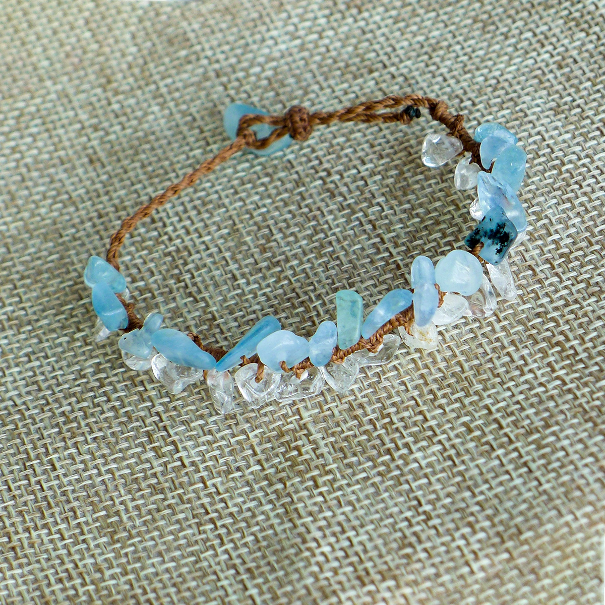 Close-up of natural aquamarine and clear quartz chips on a hand-knotted bracelet