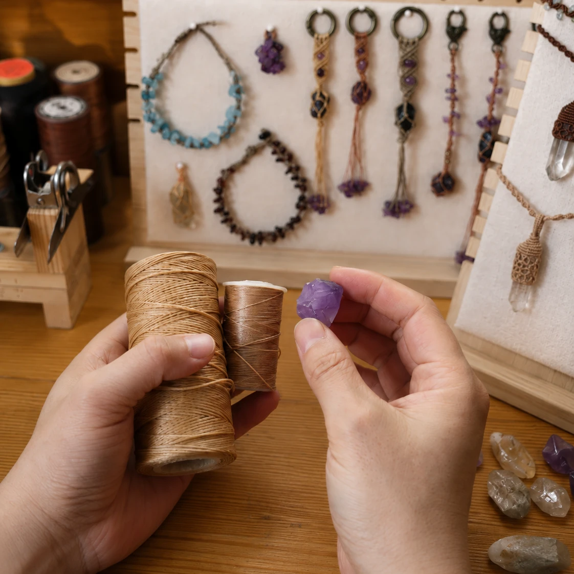 Hands selecting natural stone pieces at the Held Stone worktable.